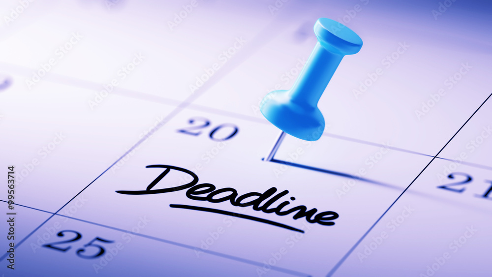 Concept image of a Calendar with a blue push pin. Closeup shot o
