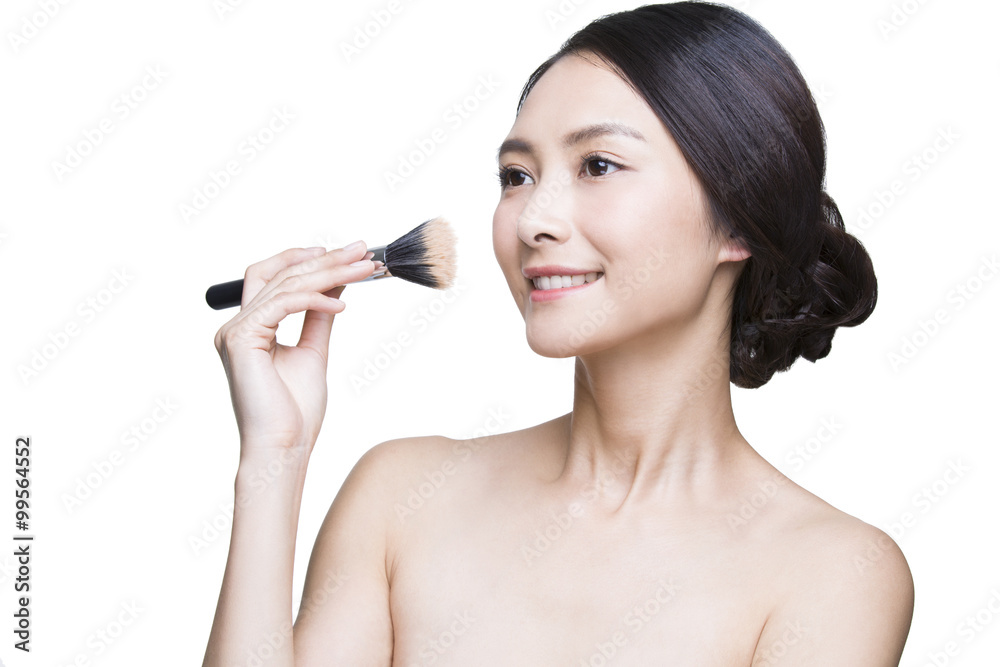 Beautiful young woman with cosmetic brush Beautiful young woman with cosmetic brush