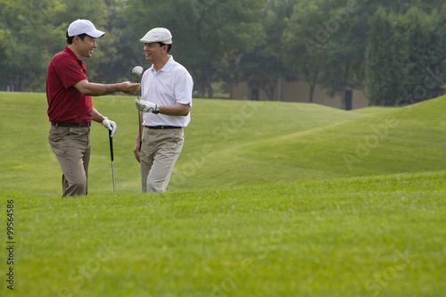 Two golfers chatting on the course