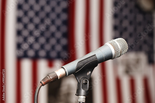 Old vintage microphone on the background of the American flag