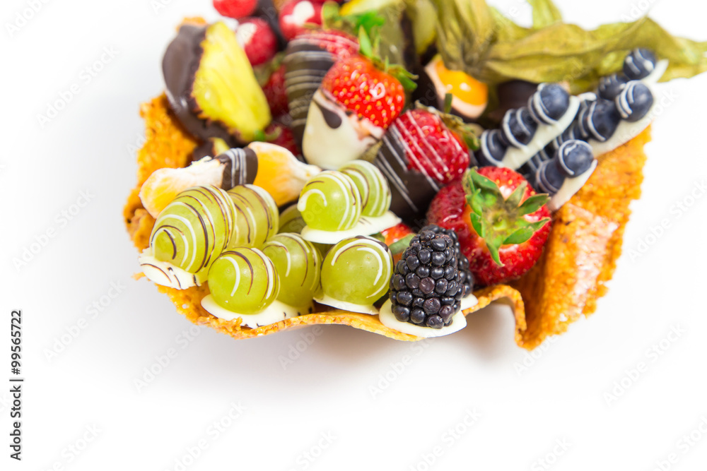 Variety of fresh fruits with decorative chocolate on white background 