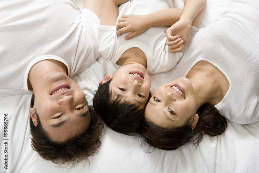 Portrait of a young family on a bed Portrait of a young family on a bed