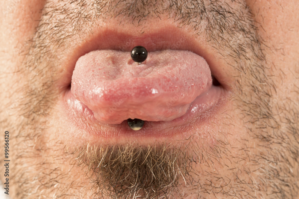 Fototapeta premium Man showing off his tongue ring
