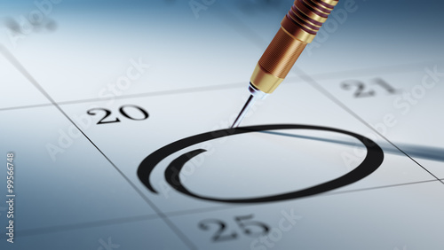 Concept image of a Calendar with a golden dart stick.. Circle ma