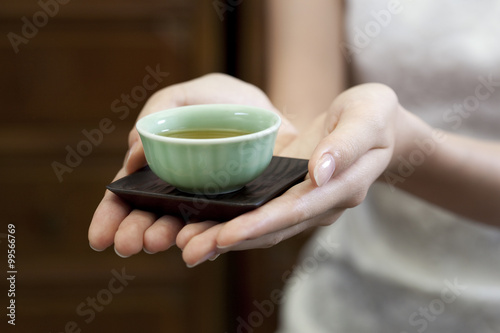 Young woman serving Chinese tea