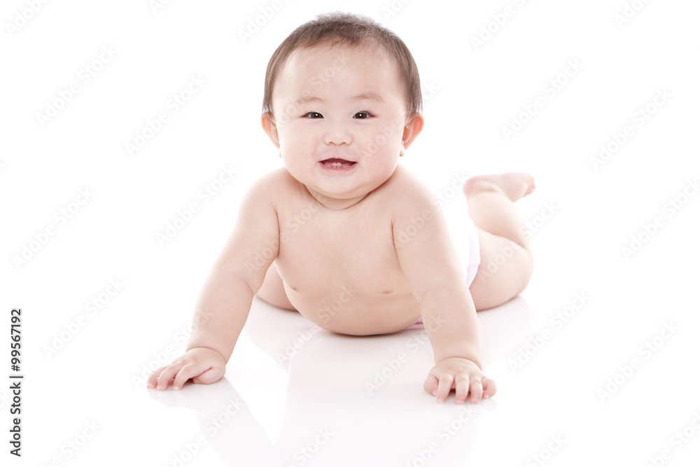 Studio shot of cute baby lying on floor Studio shot of cute baby lying on floor