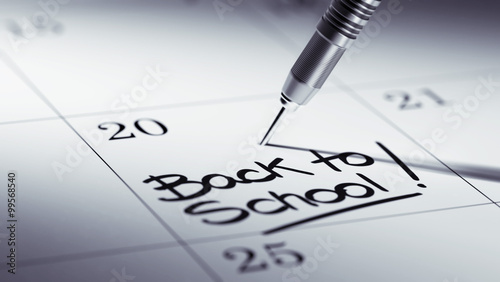 Concept image of a Calendar with a golden dart stick.. The words