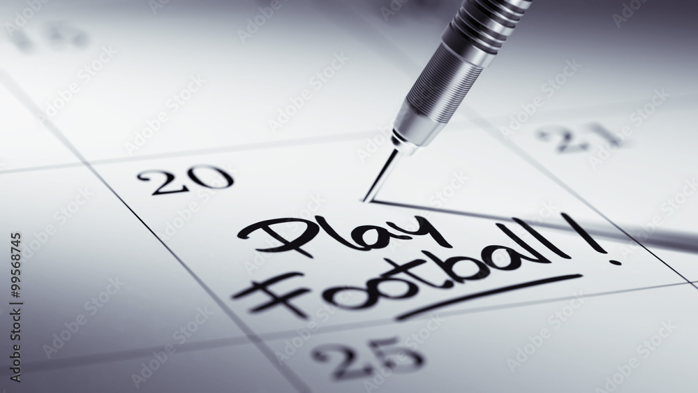 Concept image of a Calendar with a golden dart stick.. The words Concept image of a Calendar with a golden dart stick.. The words