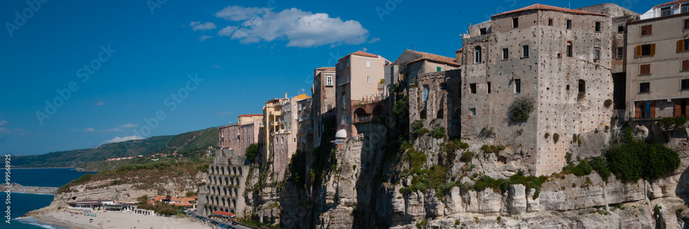 Italian houses fronting the sea on cliff over coast of Tropea