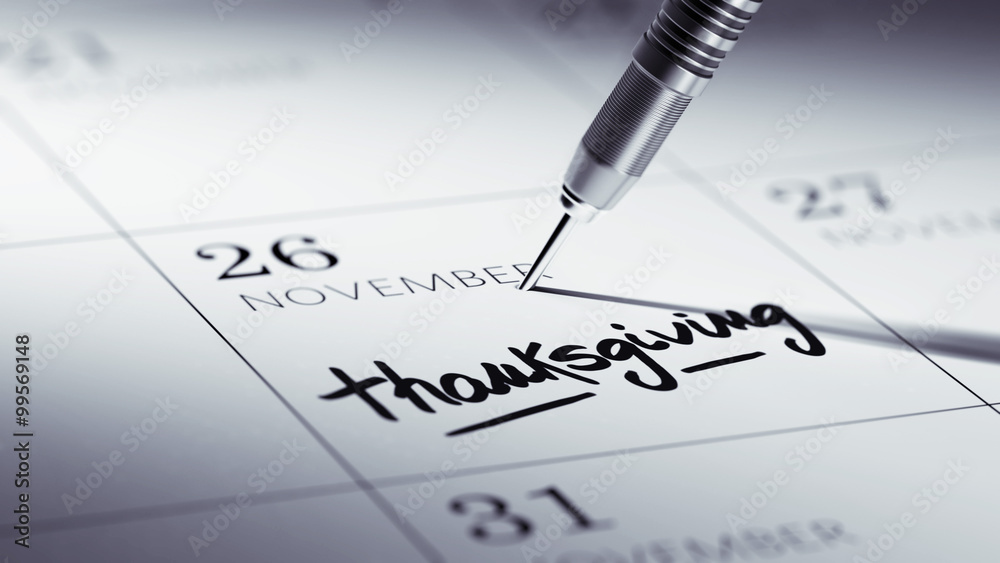 Concept image of a Calendar with a golden dart stick. Thanksgivi Concept image of a Calendar with a golden dart stick. Thanksgivi