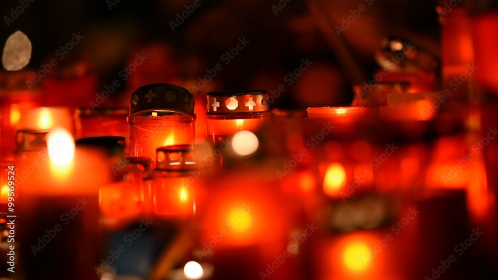 Night shot with burning candles lit in the memory of dead people