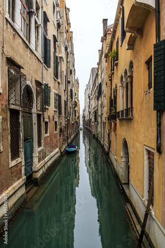 Fototapeta Naklejka Na Ścianę i Meble -  Picturesque view of Gondolas on lateral narrow Canal on a foggy day, Venice, Italy.