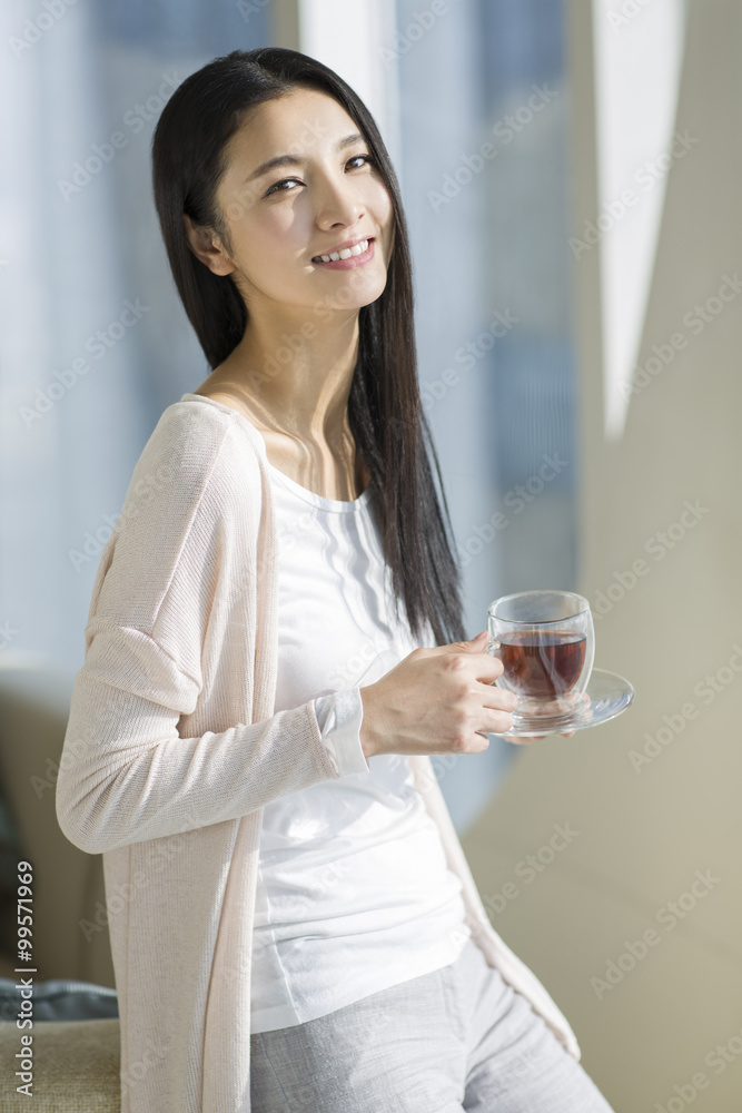Happy young woman drinking black tea Happy young woman drinking black tea