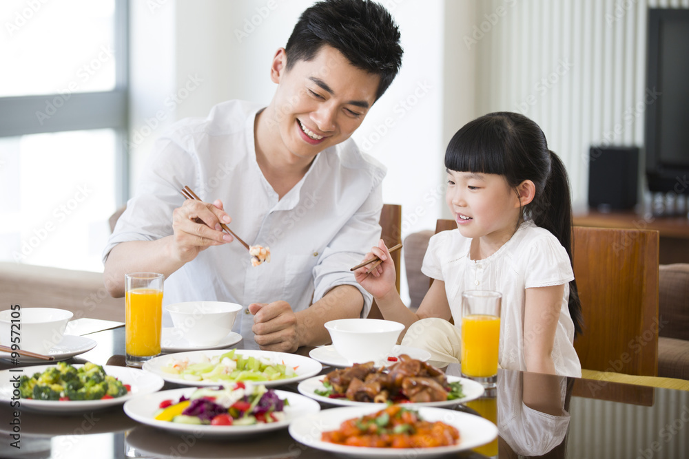 Happy father and daughter having lunch