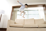 Child jumping on couch
