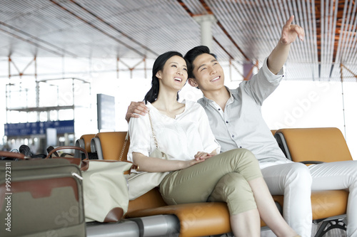 Young couple waiting in airport lounge