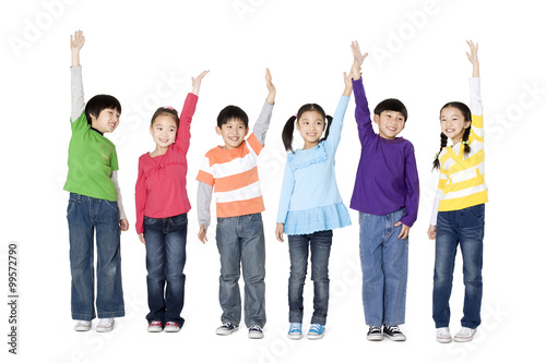 A group of children holding their hands in the air
