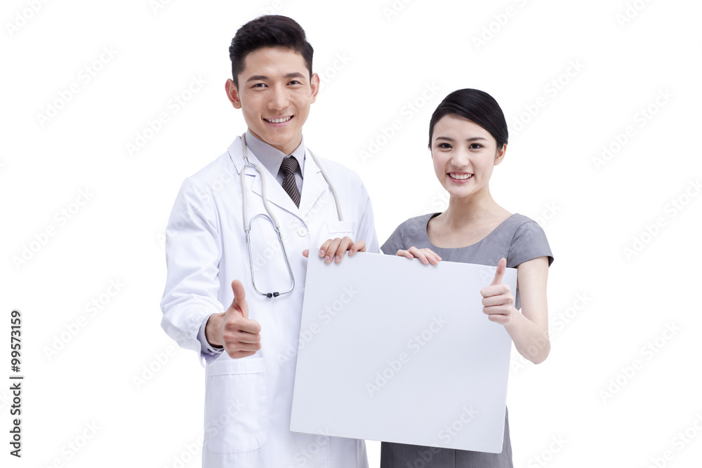 Doctor and young woman holding whiteboard Doctor and young woman holding whiteboard
