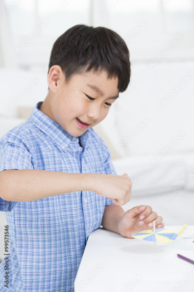 Boy playing a paper toy