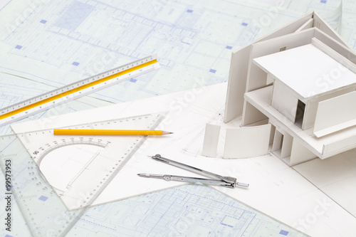 Architectural model and other office stationery on blueprint