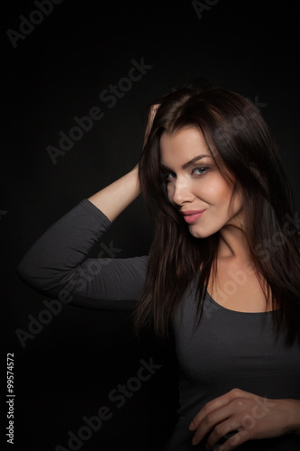 Portrait of a Beautiful Woman Model black background studio - Stock Image