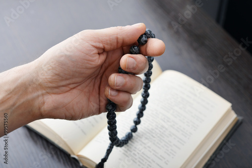 Hand with rosary beads