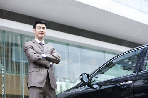 Young businessman and car © Blue Jean Images