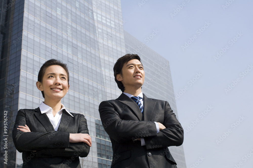 Business partners standing confidently together Business partners standing confidently together