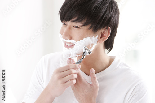 Young man doing shaving