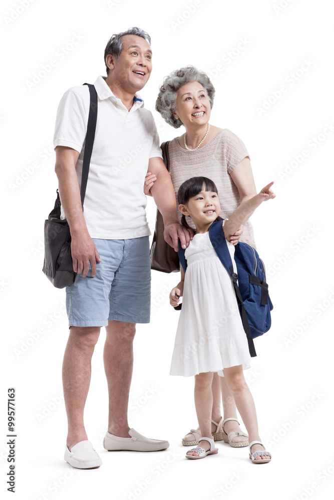 Joyful grandparents and granddaughter looking at view