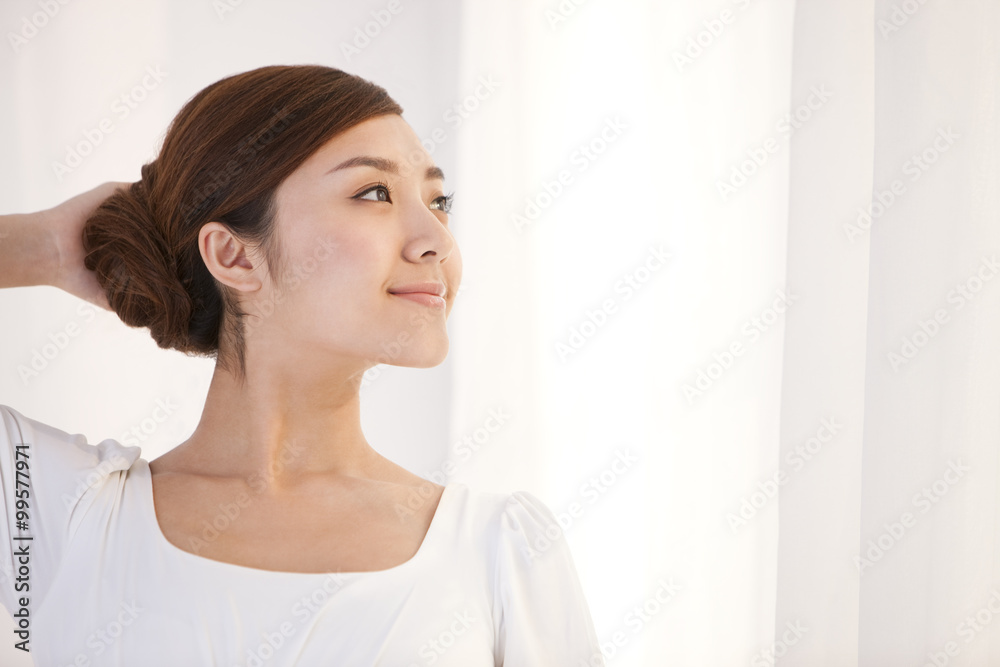 Young woman smiling and looking to the distance Young woman smiling and looking to the distance