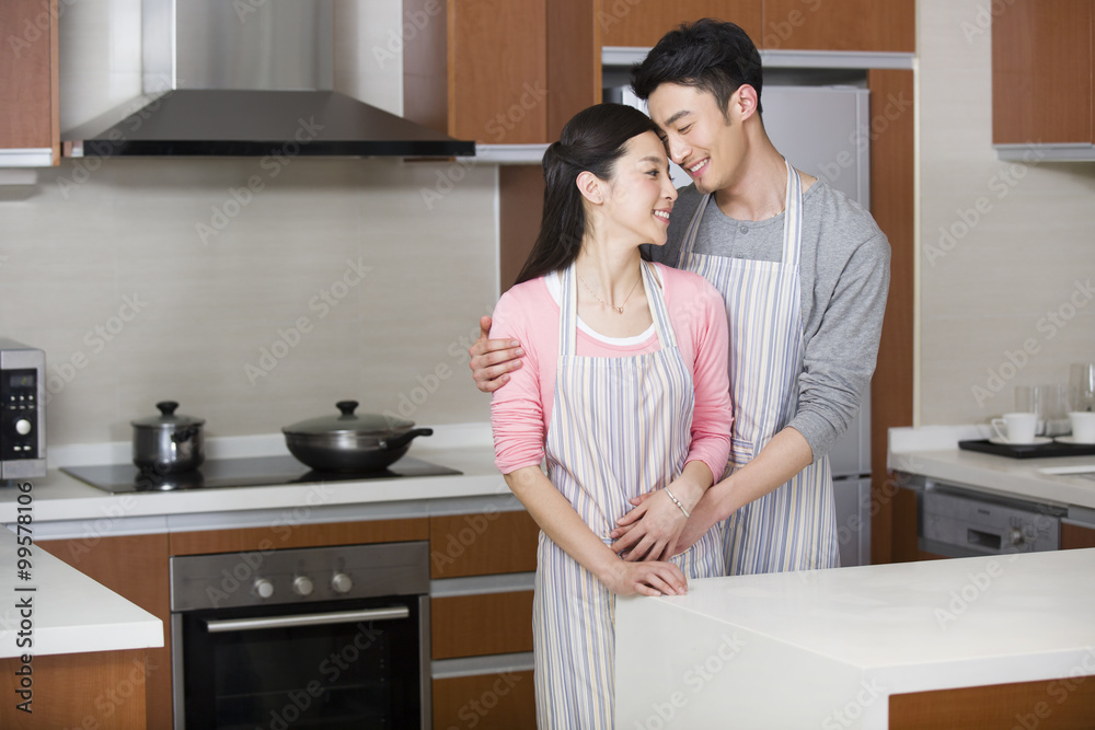 Happy young couple in kitchen Happy young couple in kitchen