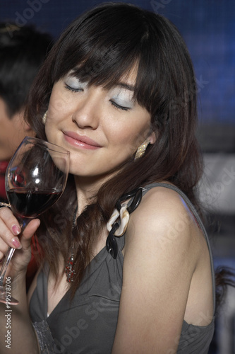 Beautiful Woman Drinking Red Wine In A Nightclub