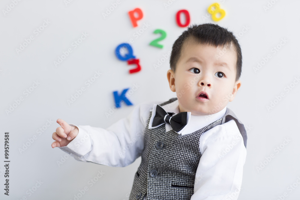 Cute baby playing with alphabet and number toys Cute baby playing with alphabet and number toys
