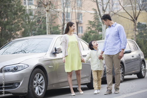 Happy young family and car