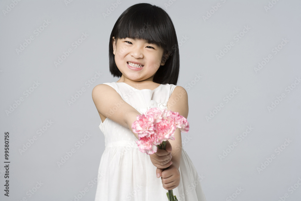 Little girl holding a bunch of flowers