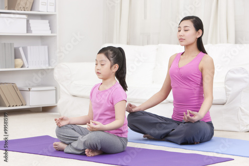 Monther and daughter doing yoga
