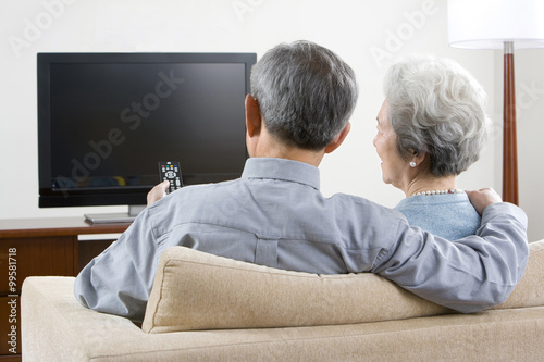 Elderly couple in front of widescreen television