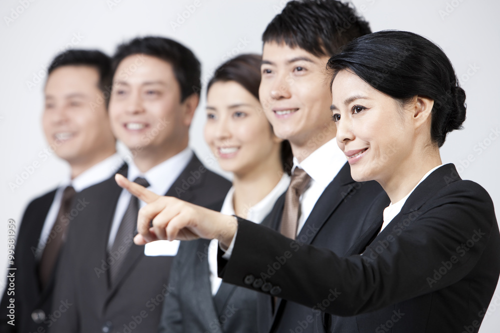 Joyful business coworkers pointing and looking at view Joyful business coworkers pointing and looking at view
