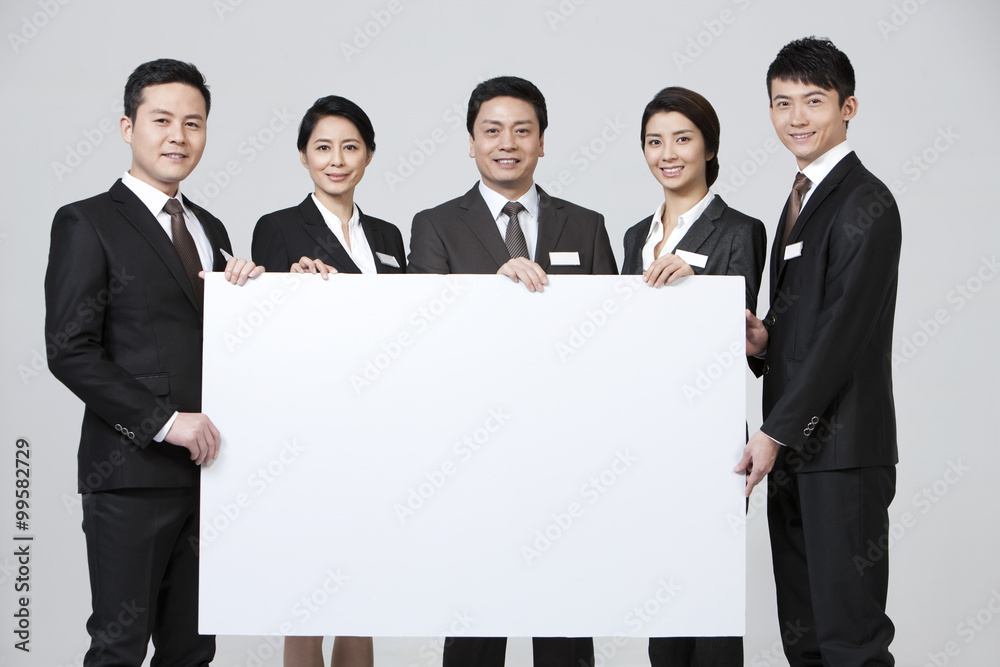 Happy business coworkers with a blank whiteboard Happy business coworkers with a blank whiteboard