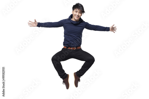 Stylish young man jumping in mid-air