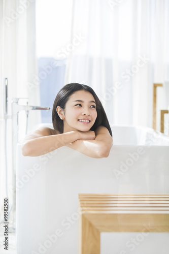 Young woman relaxing in bathtub