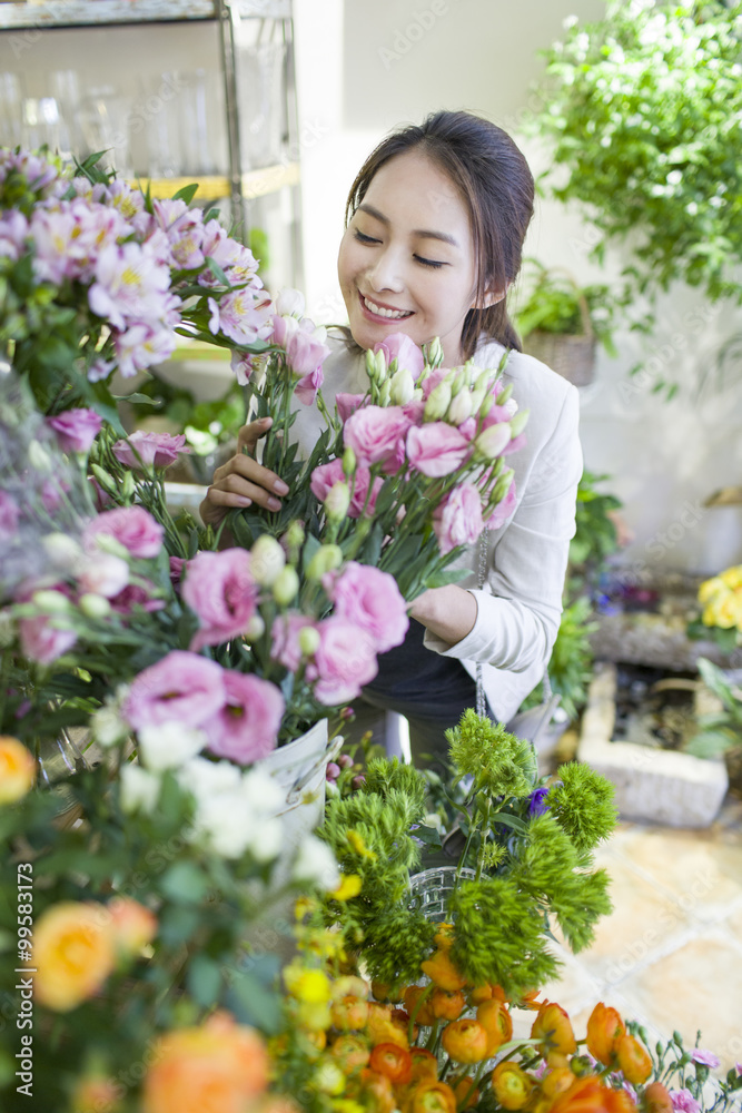 Young woman buying flowers