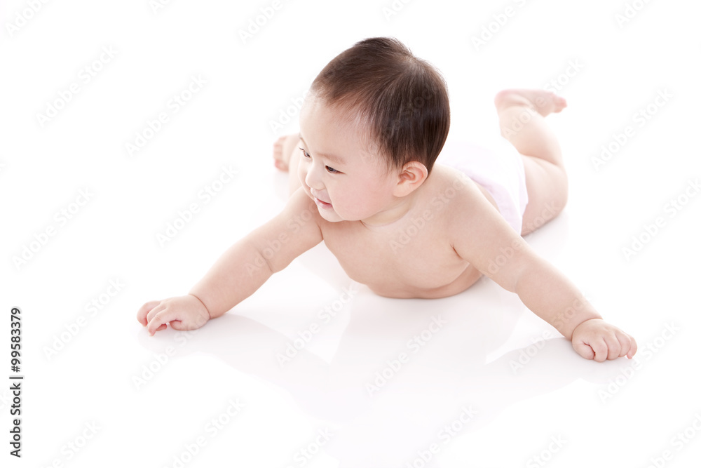 Studio shot of cute baby lying on floor Studio shot of cute baby lying on floor