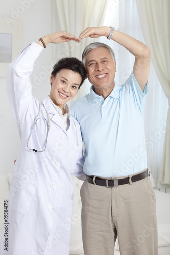 Doctor and patient doing a heart shape gesture