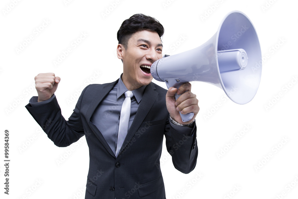 Cheerful businessman shouting into megaphone Cheerful businessman shouting into megaphone