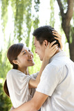 Young Chinese couple embraching in a park