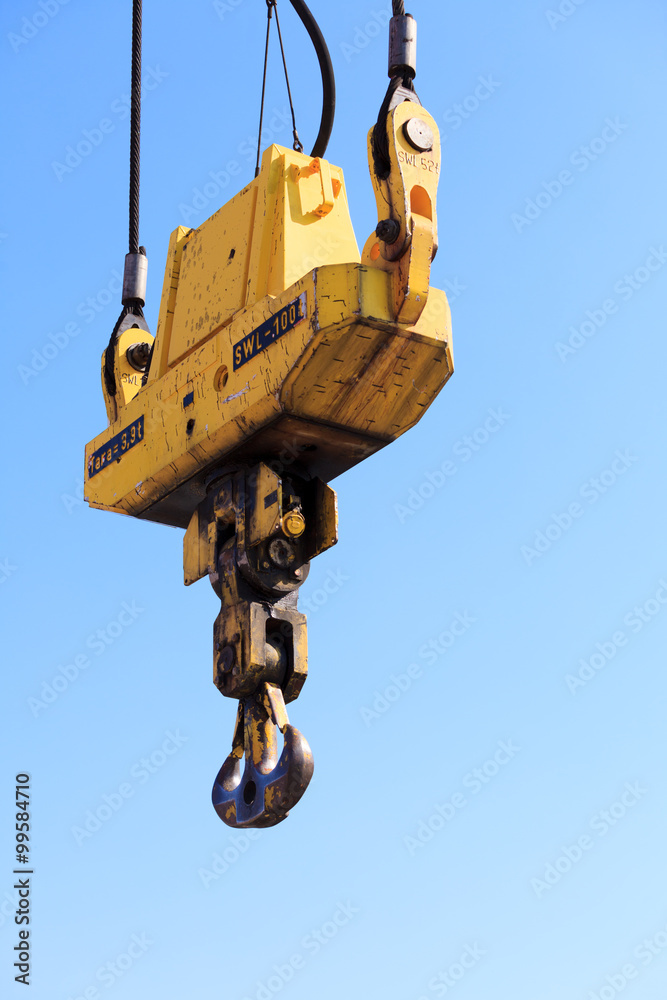 Crane hook at port area and blue sky Crane hook at port area and blue sky