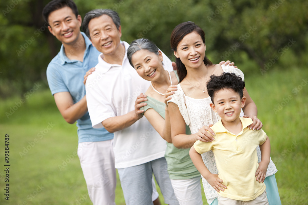 Happy family standing in a row outdoors Happy family standing in a row outdoors