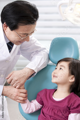 Dentist and little patient in dental clinic